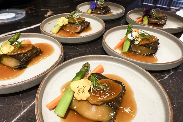 Plated dishes prepared for a catered corporate event