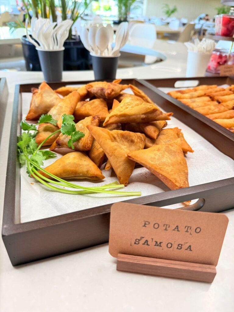 Potato samosas served on a tray at a staff tea break