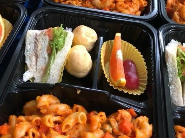 Bento sets with tomato macaroni, sandwich, cream puffs and fresh fruit