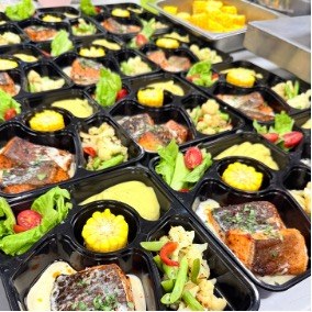 Bento sets with salmon, salad and corn