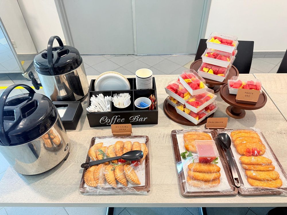 Coffee bar with sardine puffs, hash browns and fruit cups for a staff event