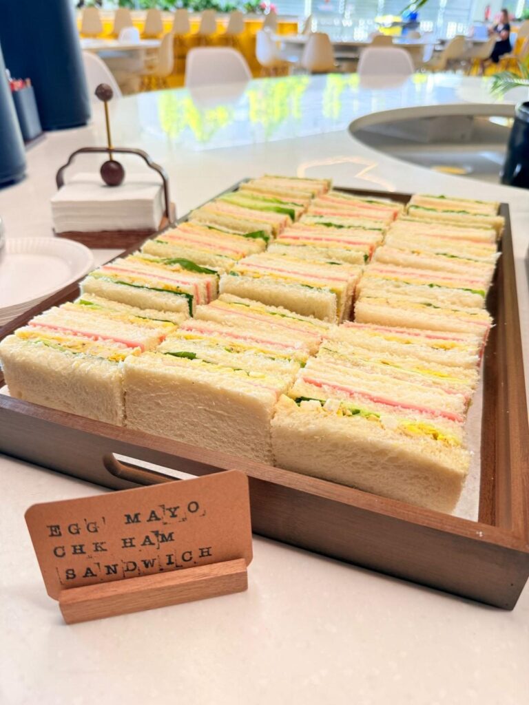 Tray of egg mayo and chicken ham finger sandwiches for a staff tea break