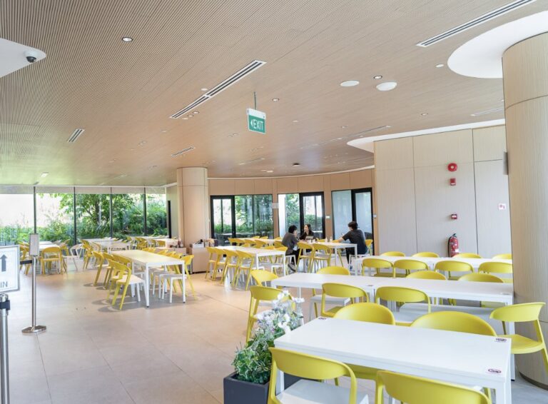 Bright staff cafeteria dining hall in Singapore with garden views